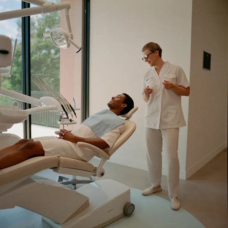 Patient relaxed in a modern dental chair talking with a dentist in Turkiye